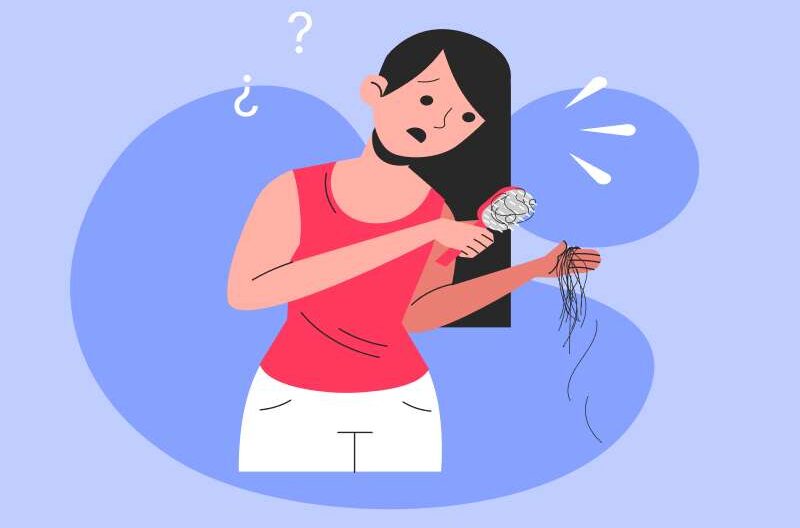 A worried woman looking at hair strands falling out while brushing, symbolizing hair loss concerns.